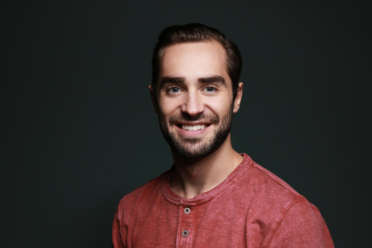 Young handsome man smiling on color background