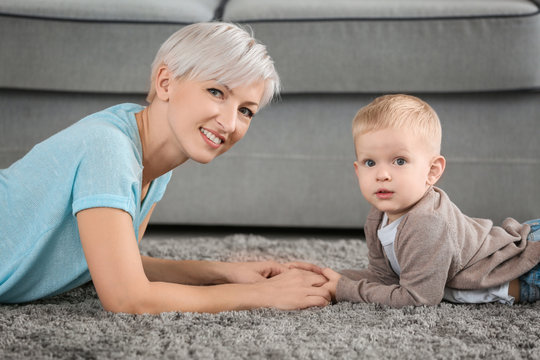 Attractive young mother with her baby at home