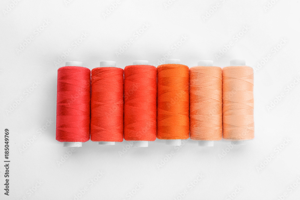 Wall mural Colorful sewing threads on white background