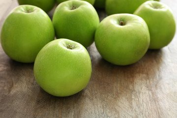 Fresh green apples on wooden background