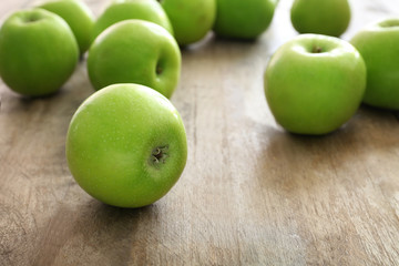Fresh green apples on wooden background