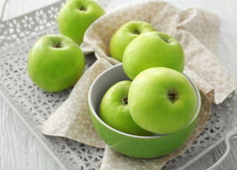 Tray with fresh green apples on wooden background