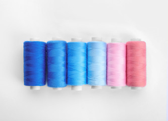 Colorful sewing threads on white background
