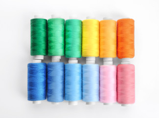 Colorful sewing threads on white background