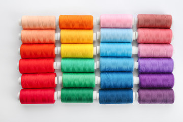 Colorful sewing threads on white background