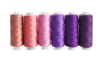 Colorful sewing threads on white background