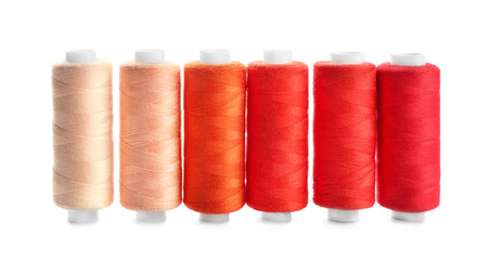Colorful sewing threads on white background