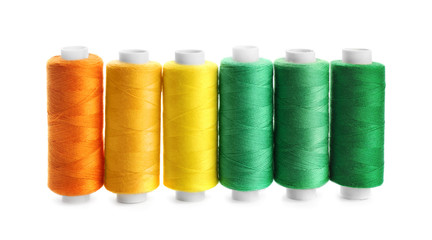 Colorful sewing threads on white background