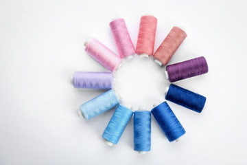 Colorful sewing threads on white background