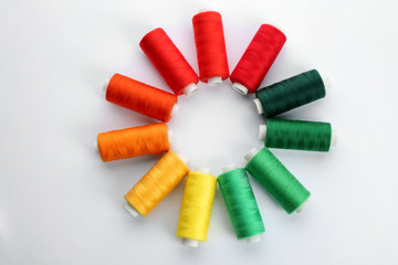 Colorful sewing threads on white background