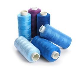 Colorful sewing threads on white background