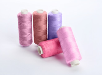 Colorful sewing threads on white background
