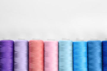 Colorful sewing threads on white background
