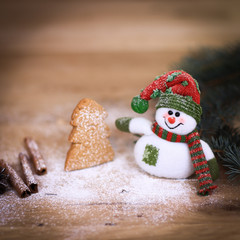 Christmas Cup and a toy snowman on wooden background