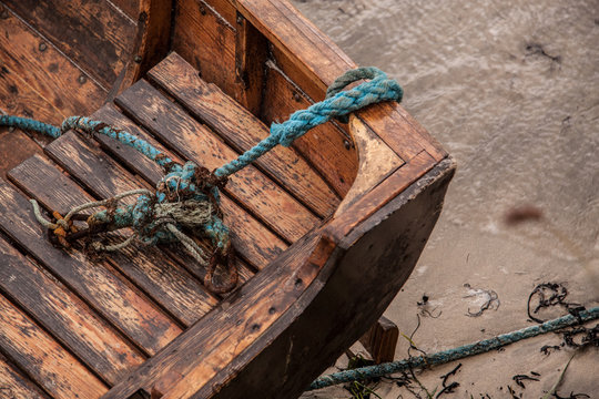 Closeup of a rotten, stranded boat with distorted knots of ropes at the beach at the Lofoten Islands, Norway