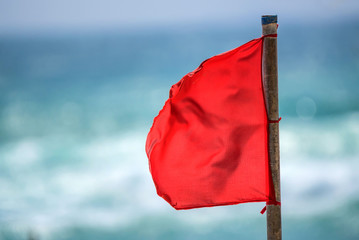 Red warning flag on beach