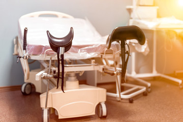 Empty delivery room with bed and medical equipment  in the maternity ward at a hospital