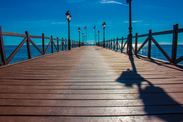 Fototapeta premium Pier. Wooden pier in Marbella. Malaga province, Costa del Sol, Andalusia, Spain.