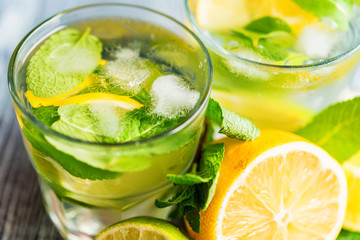 Lemonade or mojito cocktail with lemon and mint