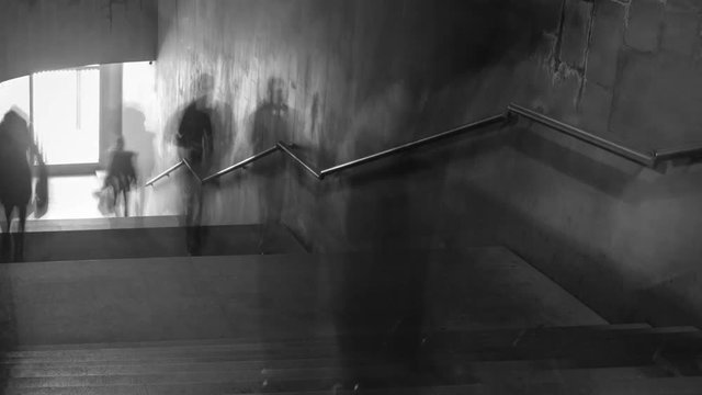 Time Lapse of black and white pictures of walking people on the stairs