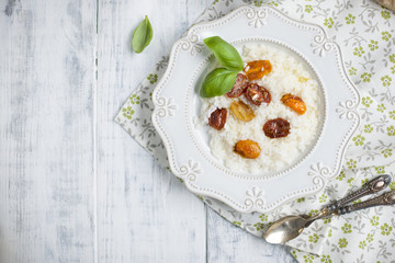 risotto with tomatoes, homemade bread on white background