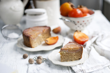 sweet homemade pastries with persimmons, on white tableware and white background