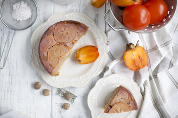 sweet homemade pastries with persimmons, on white tableware and white background