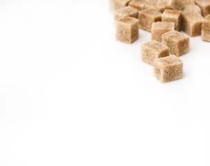 Cane sugar cubes on white background