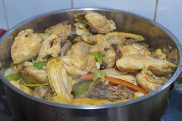 chopped chicken cooking in the kitchen pot