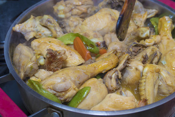 chopped chicken cooking in the kitchen pot