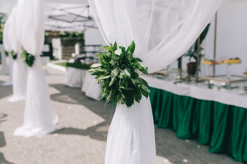 Beautiful wedding sweet buffet with decor and green.