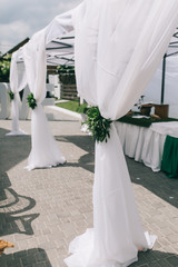 Beautiful wedding sweet buffet with decor and green.