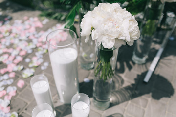 Green arch, flowers and decor for wedding ceremony.