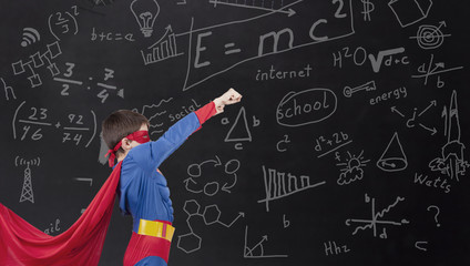 boy in a hero costume on the school board