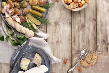 food on a wooden background and old fork on a napkin