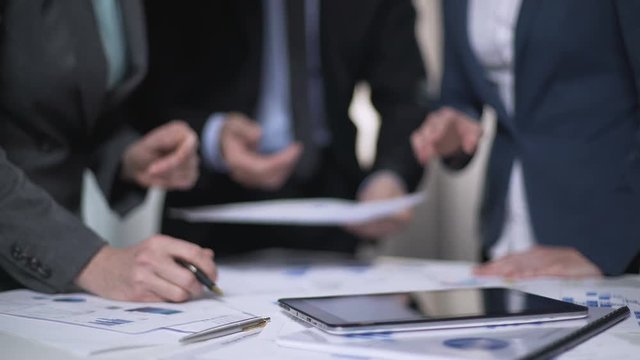 Business consultant giving advise to managers, discussing development plan