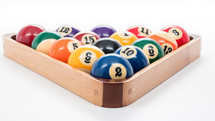 Pool balls in an wooden rack for playing a game