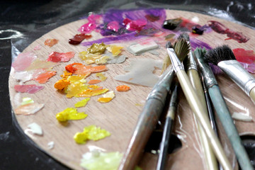 artists paint brushes on wooden palette