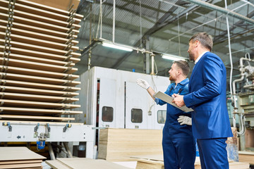 Portrait of  mature inspector touring modern factory for safety and  quality of production,...