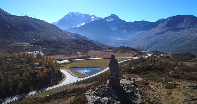 Stone statue, Cinema 4k aerial orbit view around the eagle statue monument, on the top of simplon pass, on a sunny autumn day, in Valais, in the alps of Switzerland