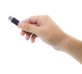 Hand holding black USB cable on white background