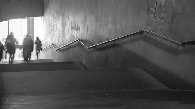 Time Lapse of black and white pictures of walking people on the stairs. 4K