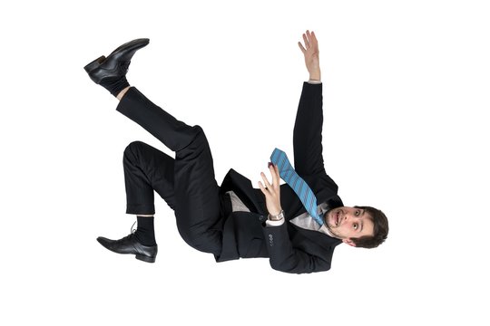 Businessman is falling down. Isolated on white background.