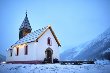 Fototapeta na wymiar Old church in the snow. Church at the foot of the glacier. Maso Corto, Sudtirol, Bolzano, Alps, Italy. Maso Corto church