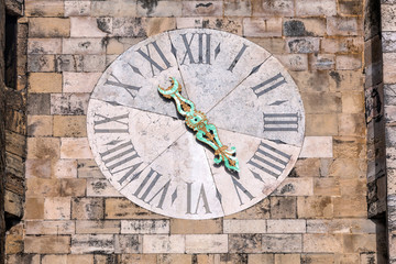 Clock on the Lisbon Cathedral's tower. The cathedral was originated in the 12th century and classified as a National Monument since 1910.