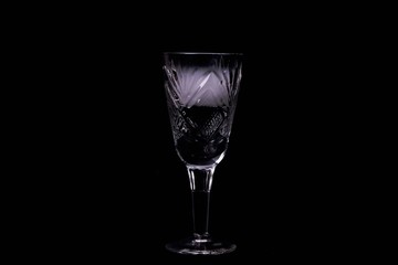 Smoke into cocktail glass on a black background. Witch potion background for Halloween. Unusual bar drink.