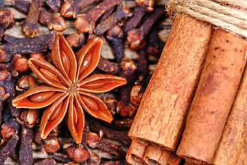 Anise star with cloves and cinnamon sticks on table