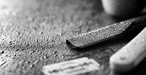 A dangerous razor and a metal blade on the table. Men's shaving 