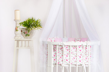 Crib. A cot for a child with a white canopy. Children's furniture.