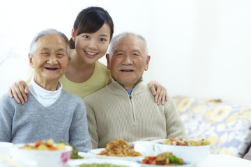 happy senior asian couple with their granddaughter in home